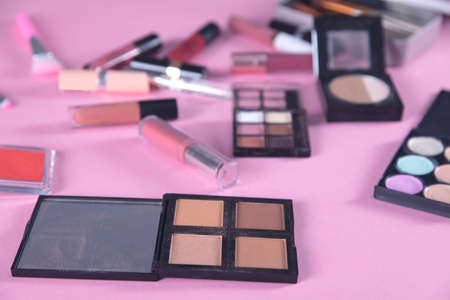 different makeup products on the pink background
