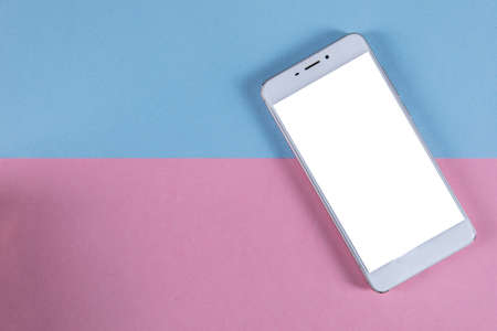 white smart phone on the color table backgroundの写真素材