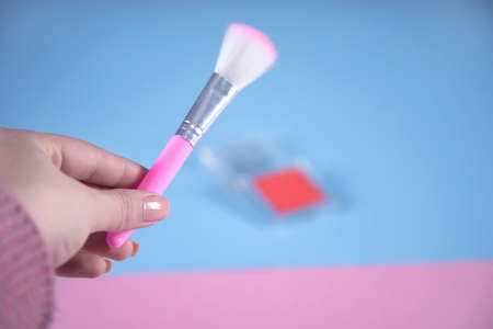 woman hand holding makeup brushesの写真素材