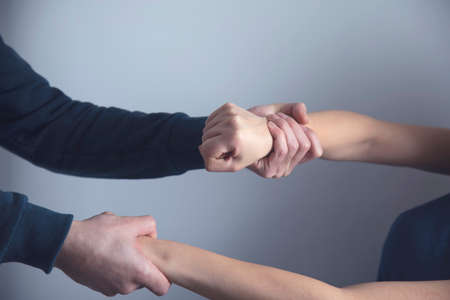 man beat sad woman on grey backgroundの写真素材