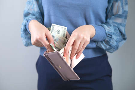 woman hand holding money with walletの写真素材