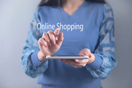 online shopping text in phone screen on grey backgroundの写真素材