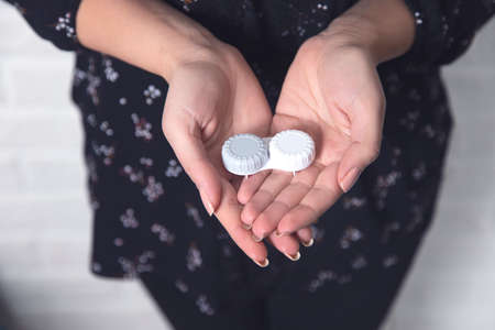 young woman hand holding optic lensesの写真素材