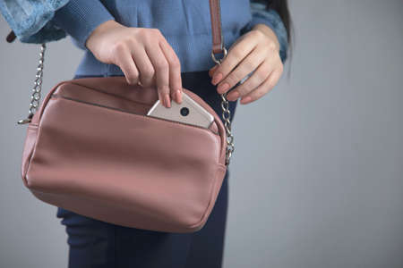 woman hand phone secret shooting and bag
