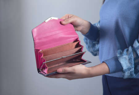 woman hand holding wallet on grey backgroundの写真素材