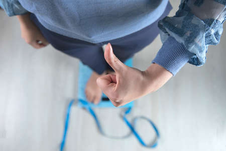 woman finger okay sign standing on the scalesの写真素材