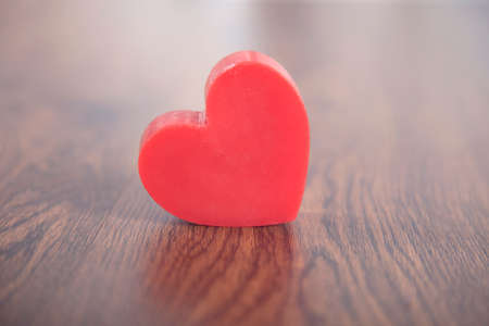 red heart on the wooden table backgroundの写真素材