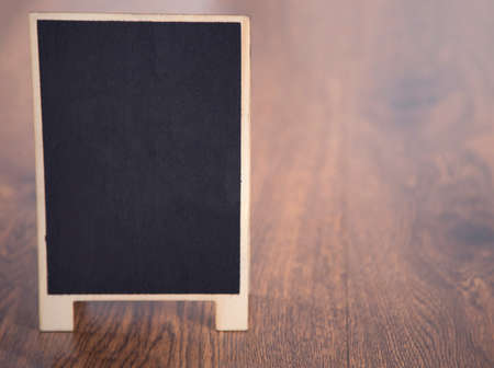 chalkboard on the wooden table backgroundの写真素材