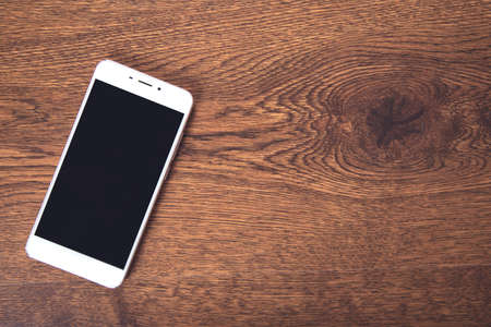 white smart phone on the table backgroundの写真素材