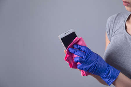 woman hand clothes and smart phone on grey backgroundの写真素材