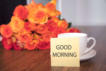 roses and coffee with good morning text on tableの写真素材