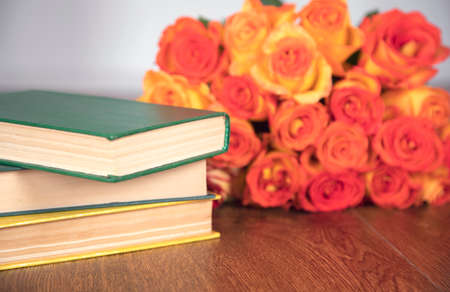 book with roses on the wooden tableの写真素材