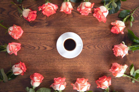 cup of coffee with roses on the tableの写真素材
