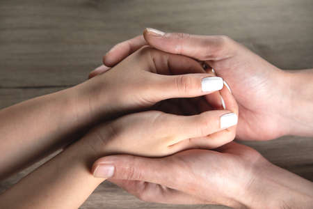 woman and man hands on the table backgroundの写真素材