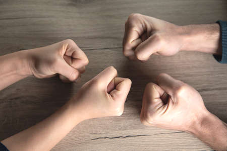 woman and man fists on table backgroundの写真素材