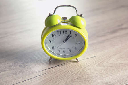 green clock on the table bckground