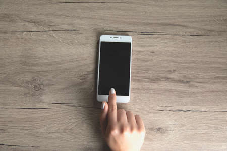 woman hand smart phone on the tableの写真素材