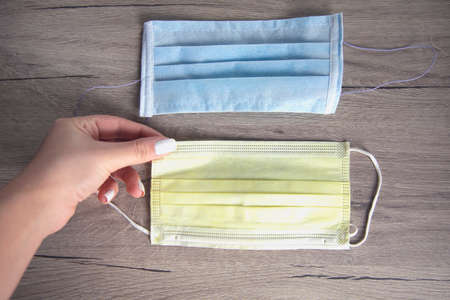 woman hand medical masks on the tableの写真素材