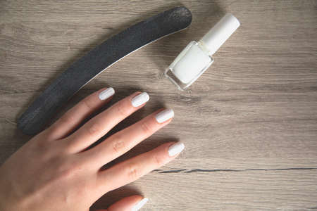 woman finger with nail polish on tableの写真素材