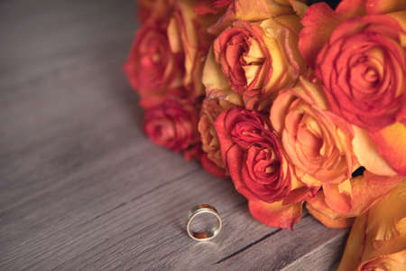 ring with bouquet of roses on the tableの写真素材