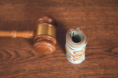 dollar and judge on the wooden tableの写真素材