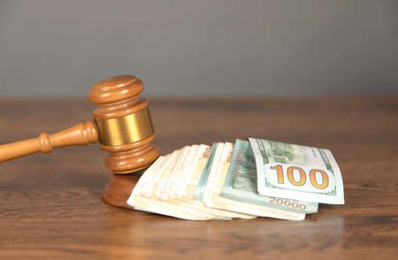 dollar and judge on the wooden tableの写真素材