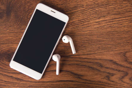 earphone and phone on  the wooden tableの写真素材