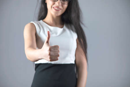 business woman hand okay sign on grey backgroundの写真素材