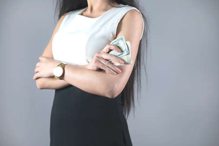 young fashion business woman hand money on grey backgroundの写真素材