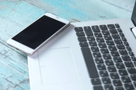 smart phone on computer keyboard on the tableの写真素材