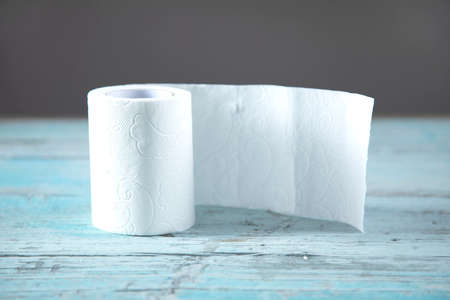 toilet paper on the blue wooden tableの写真素材