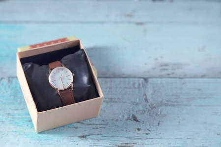 woman watch on box on the blue table
