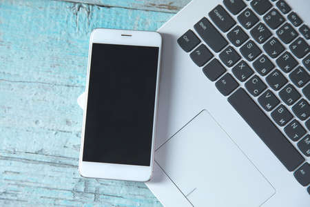 smart phone on computer keyboard on the tableの写真素材