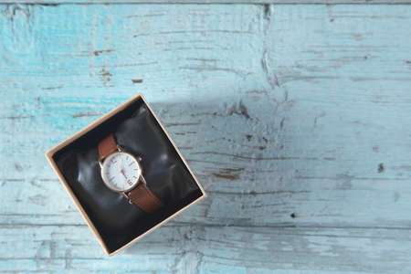 woman watch on box on the blue table