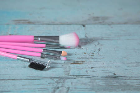 makeup brushes on the blue table backgroundの写真素材