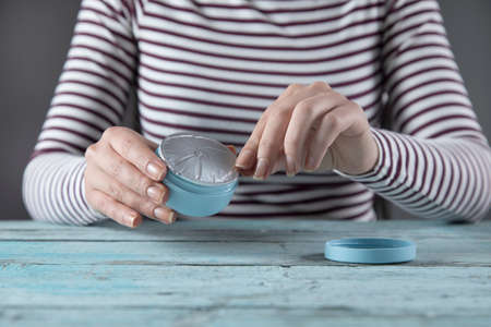 woman hand cream on the blue table