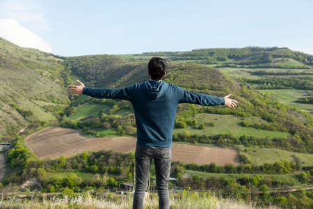 happy young man in green grass mountain