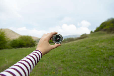 woman hand holding compass in the forestの写真素材