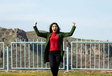 young happy woman in the mountain background