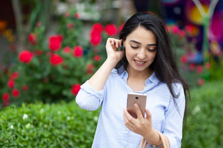 happy woman hand phone in street background