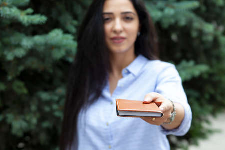 woman hand notepad in the street background
