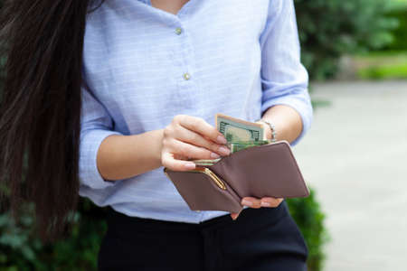 woman hand wallet and money in street