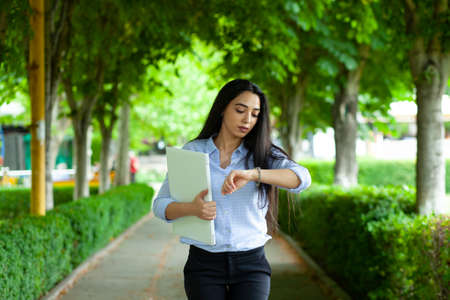 woman hand computer and watch in streetの写真素材