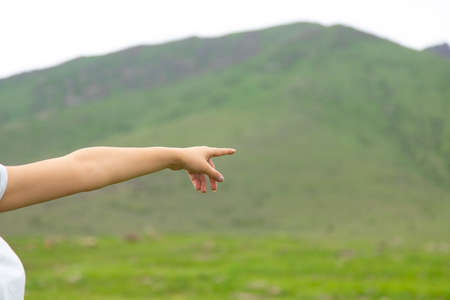 happy woman finger show the mountain backgroundの写真素材