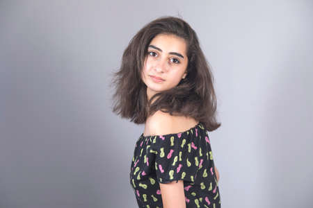 young woman in studio on gray background