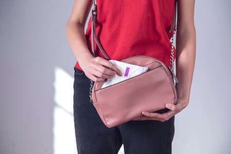 woman hand menstrual pad in the bag