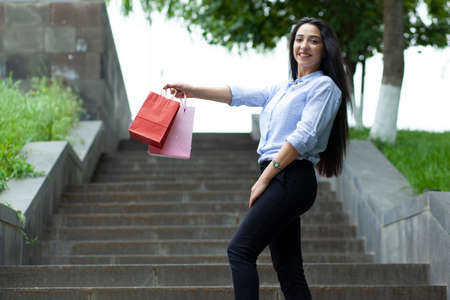 happy woman hand shopping bag in streetの写真素材