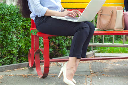 Woman working in computer in the streetの写真素材
