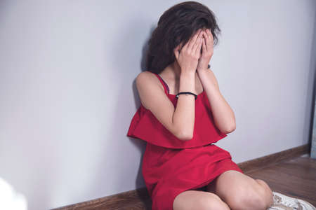 young sad woman sitting on the floor