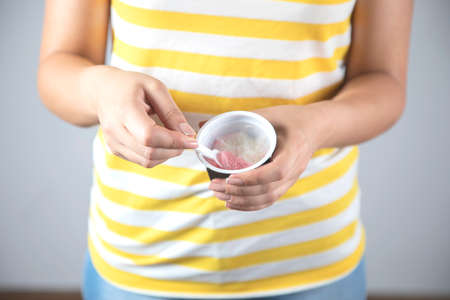 woman hand ice cream on gray background